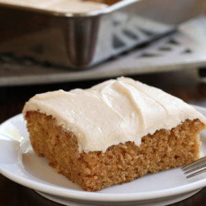Fluffy Applesauce Cake Recipe topped with cinnamon cream cheese.