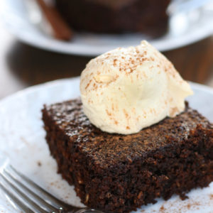 Two slices of Broonie Cake topped with whipped cream and sprinkled with cinnamon.