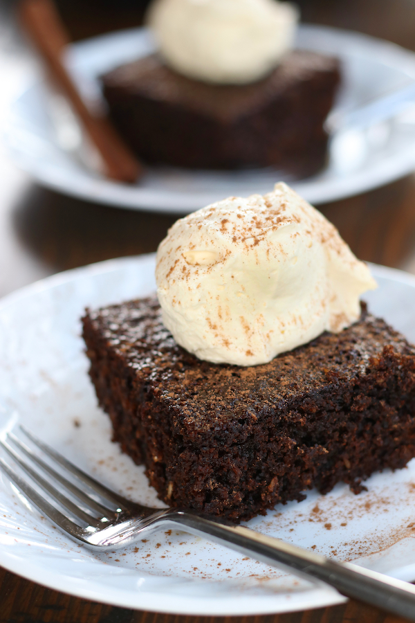 Two slices of Broonie Cake topped with whipped cream and sprinkled with cinnamon.