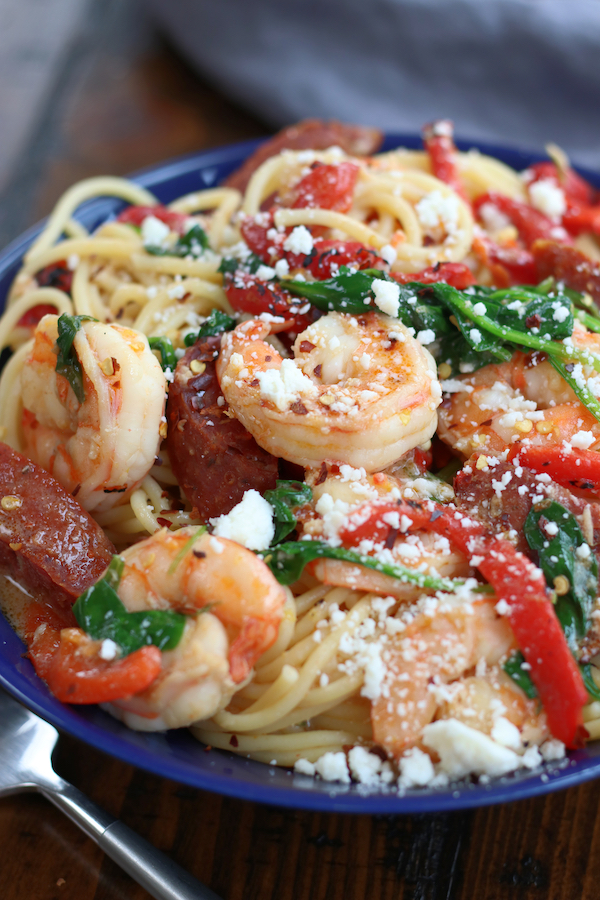 Chilli Prawn Pasta with spaghetti noodles in a bowl sitting next to a fork.