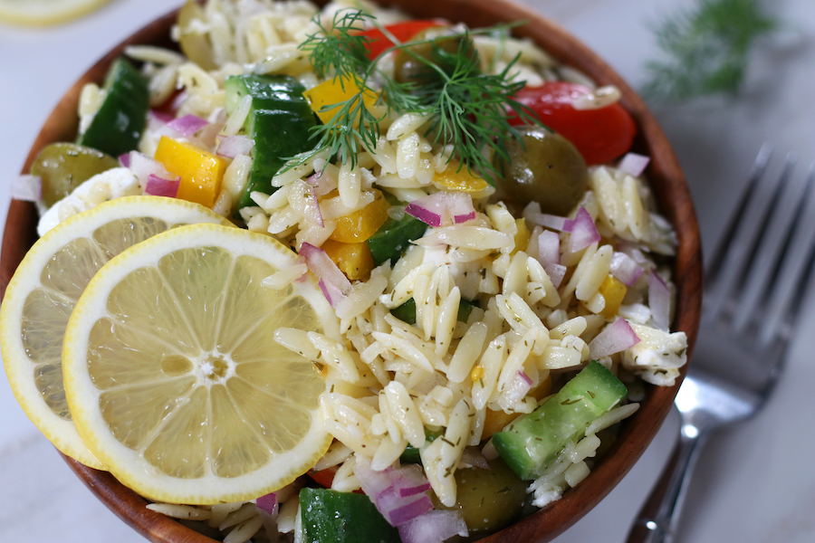 Overhead photo of Lemon Risoni Salad in a bowl on a white countertop.