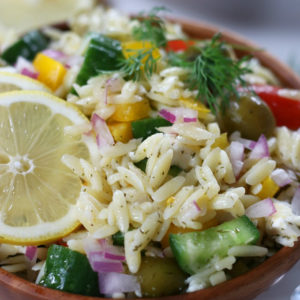 Mediterranean Risoni Salad in a wooden bowl.