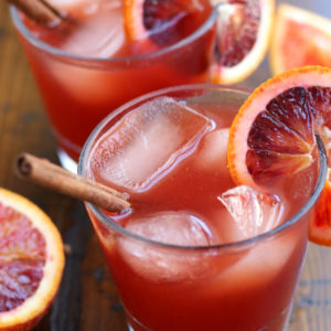 Witches Brew Recipe served into clear glasses and garnished with blood orange slices.