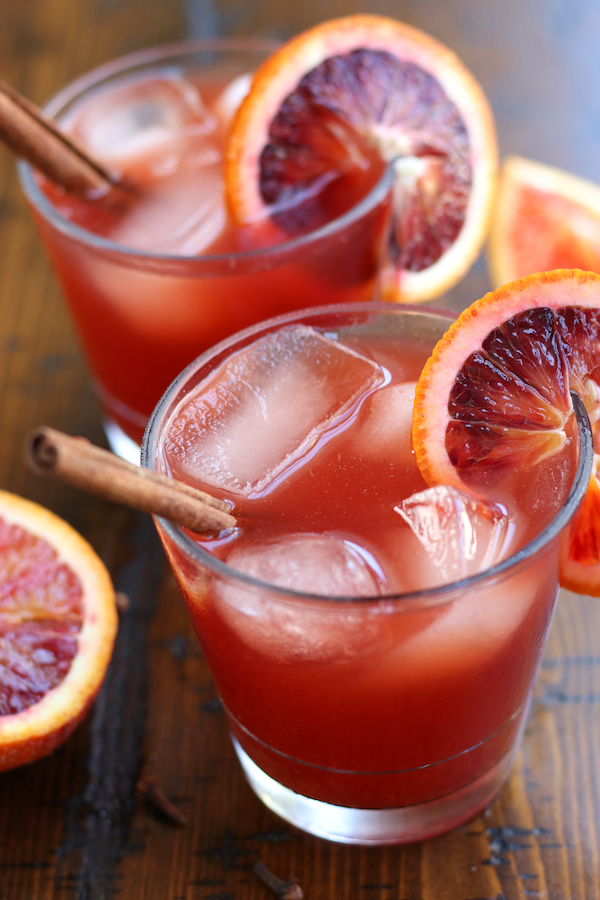 Witches Brew Recipe served into clear glasses and garnished with blood orange slices.