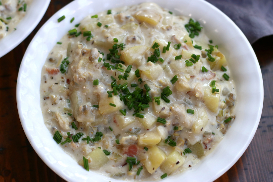 Overhead photo of Clam Chowder with Bacon, potatoes and chives.