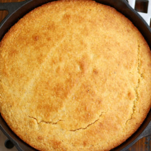 Overhead photo of Skillet Corn Bread sitting on long trivet.