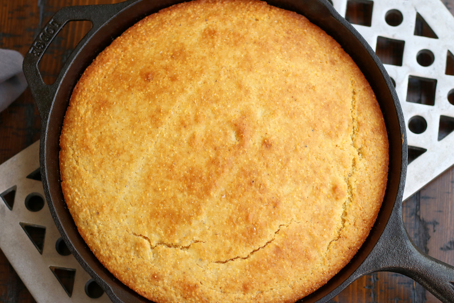 Overhead photo of Skillet Corn Bread sitting on long trivet.