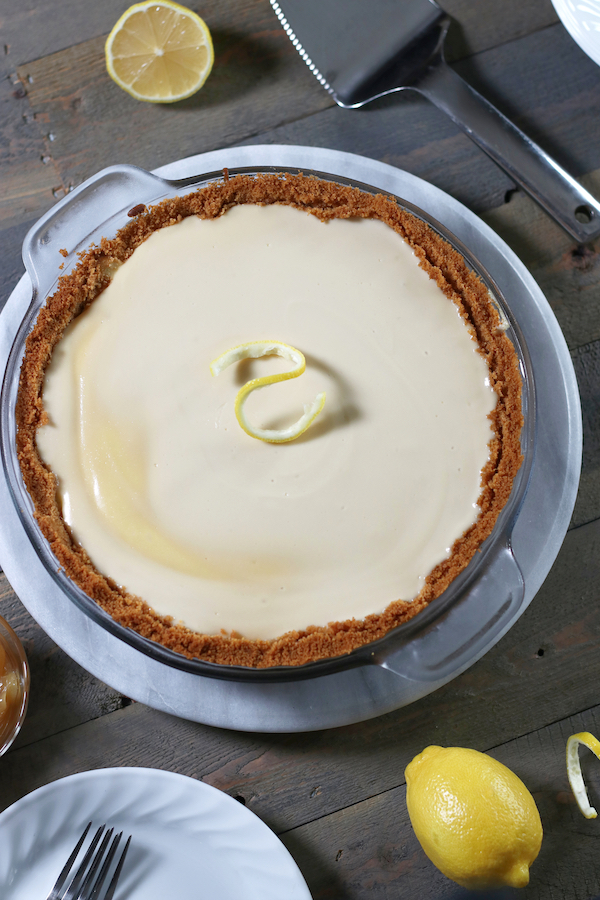 A whole Cream Cheese Pie sitting on a wooden table.