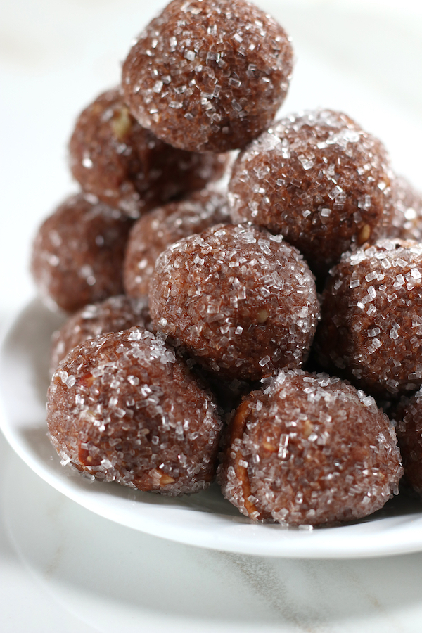 A pile of Chocolate Rum Balls rolled in sparkling sugar.