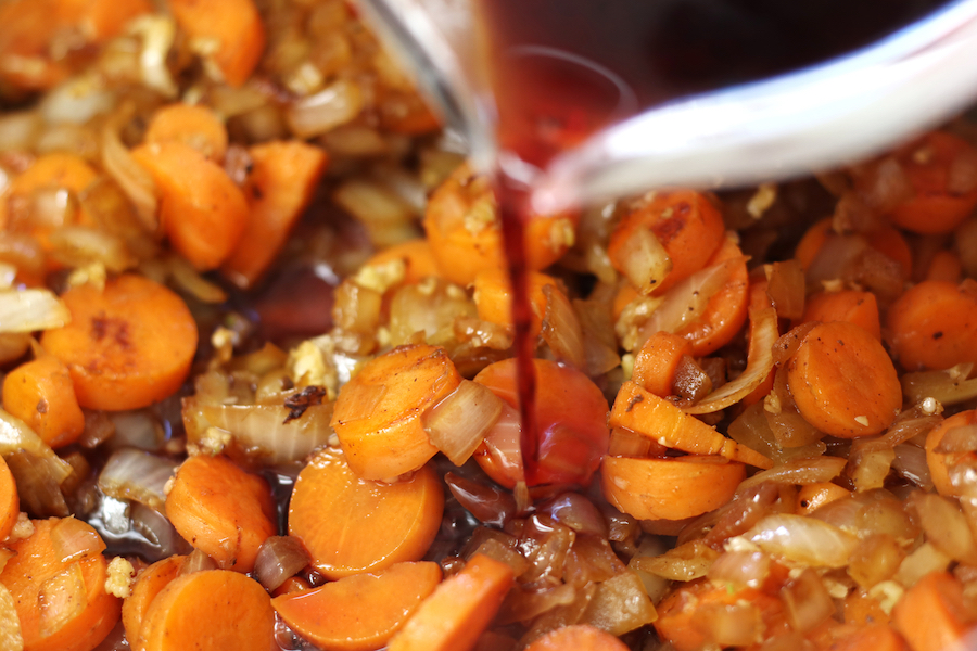 Adding of the red wine to sautéed veggies for Beef and Bean Stew.