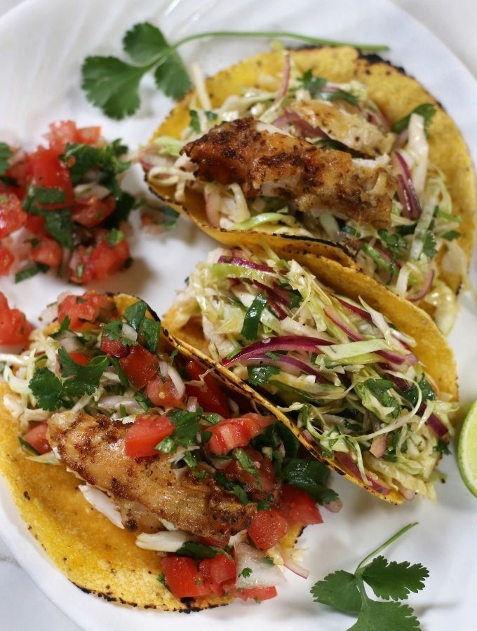 Three Baja Chicken Tacos on white plate.