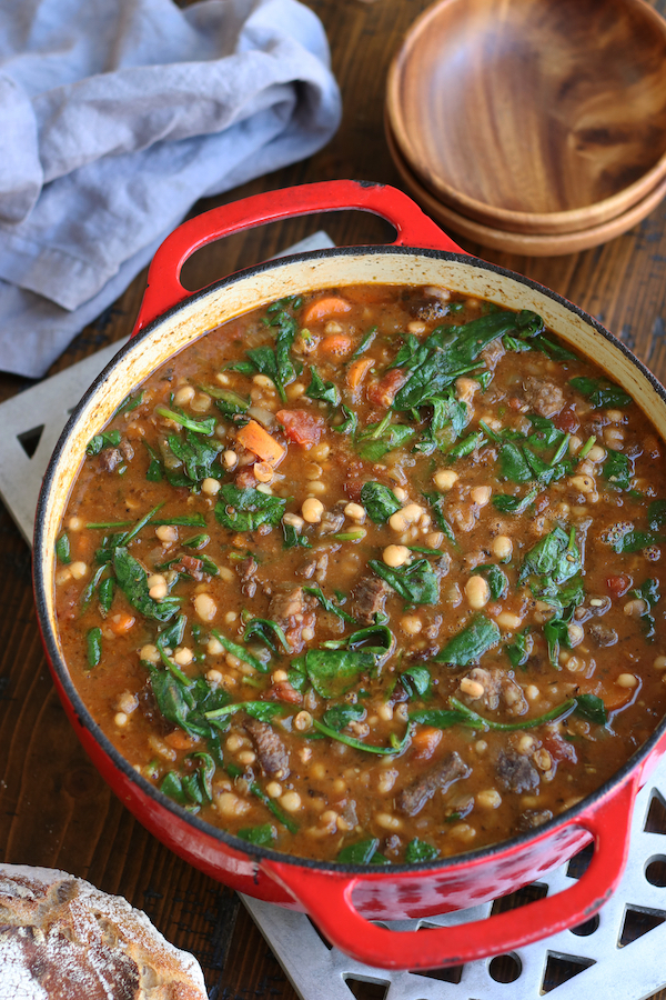 Overhead photo of a pot of Beef and Bean Soup sitting on a trivet.