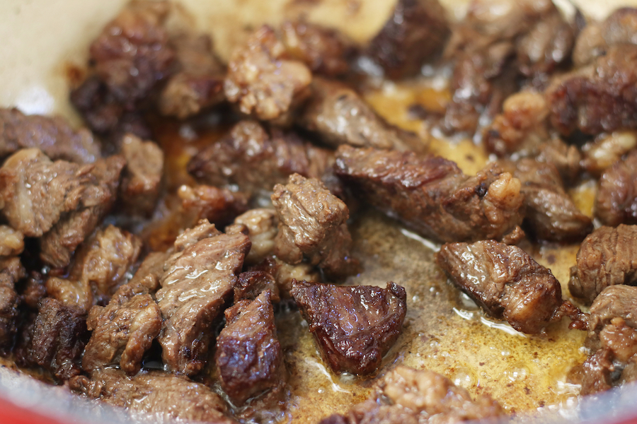 Beef browning in an enameled dutch oven for Beef and Bean Stew.