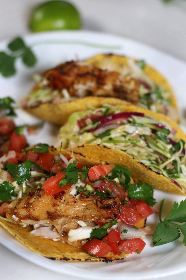 Chicken Tacos with corn tortillas and crispy marinated and baked chicken.