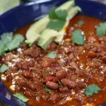 Chorizo Pinto Bean Soup in a blue serving bowl.