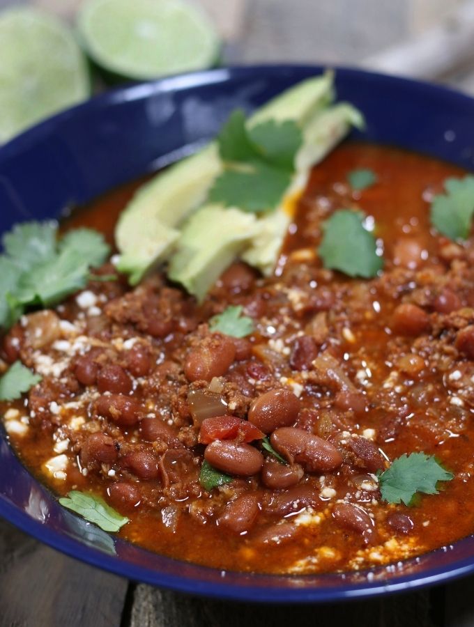 Chorizo Pinto Bean Soup in a blue serving bowl.