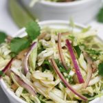 Two single servings of Mexican Cabbage Slaw in small white bowls.
