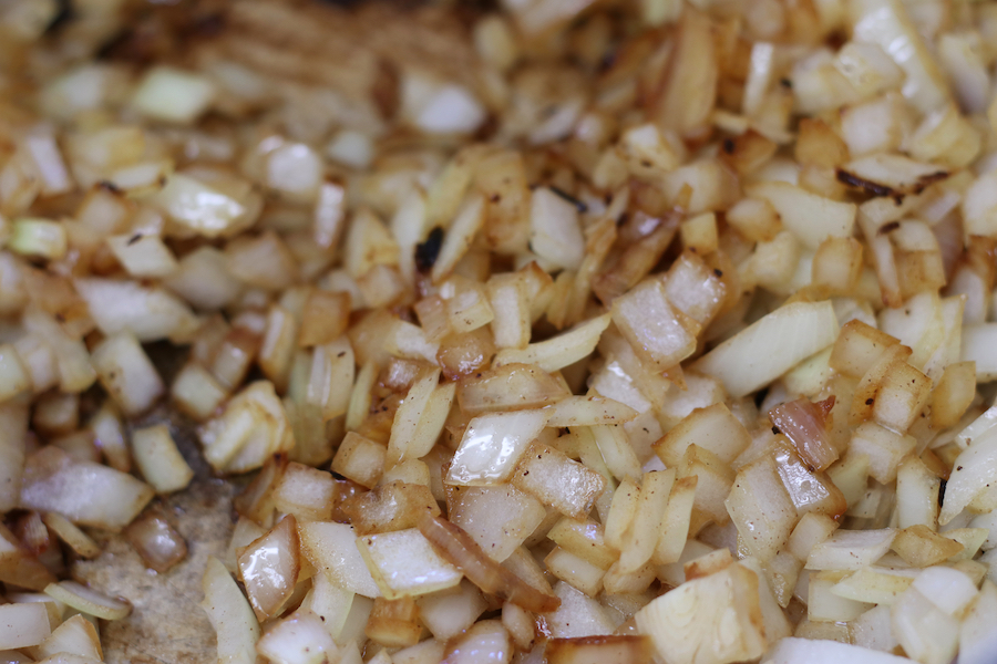 Diced onions sautéing in beef drippings for Beef and Bean Stew.