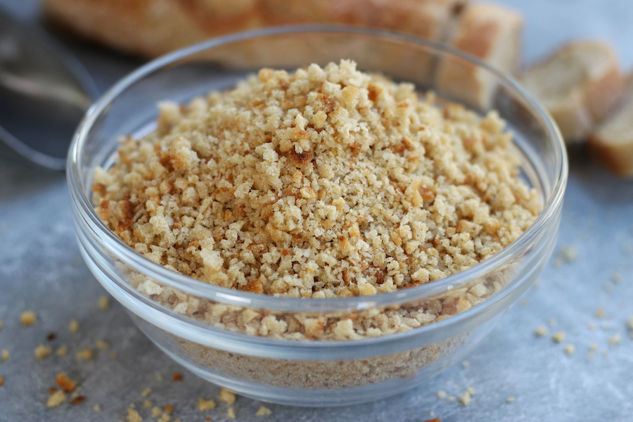 A clear glass bowl full of Dried Breadcrumbs.