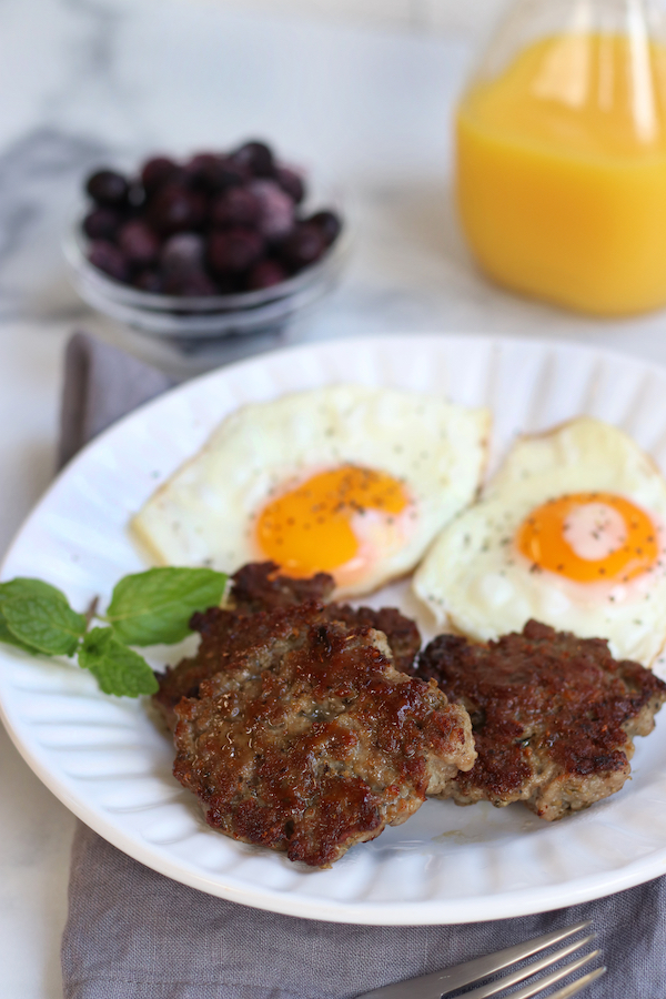 Morning Breakfast scene with Hearty Breakfast Sausage, eggs and orange juice.