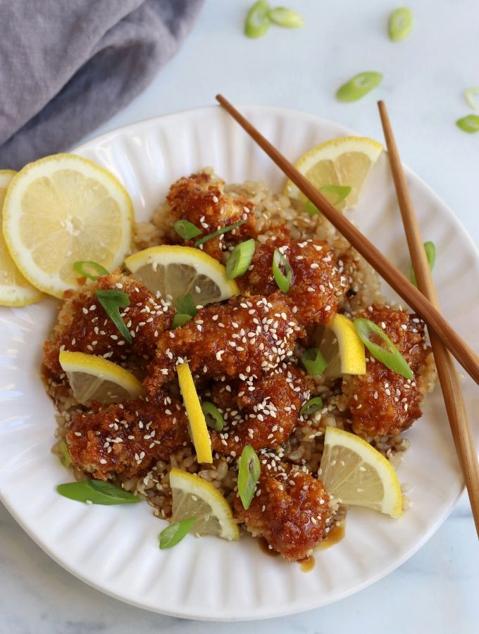Overhead photo of a serving of Baked Lemon Chicken on a white plate.