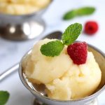 Two servings of Homemade Lemon Sorbet served in stainless steel parfait cups.