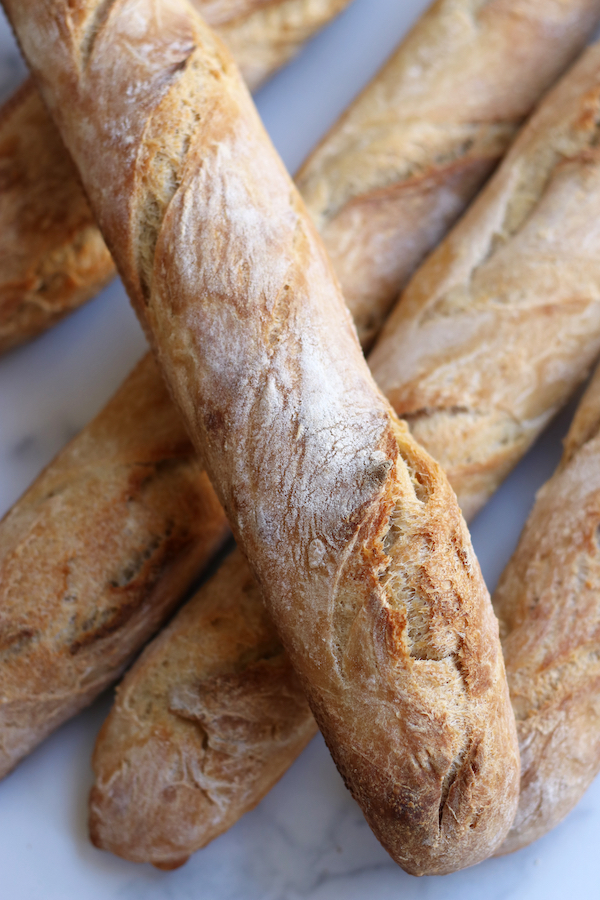 Several baguettes sitting on top of each other from a Sourdough Baguette Recipe