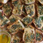 Slices of Sourdough Garlic Bread piled on top of each other.