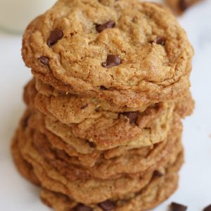 Seven Vegan Oatmeal Chocolate Chip Cookies stack on top of each other.