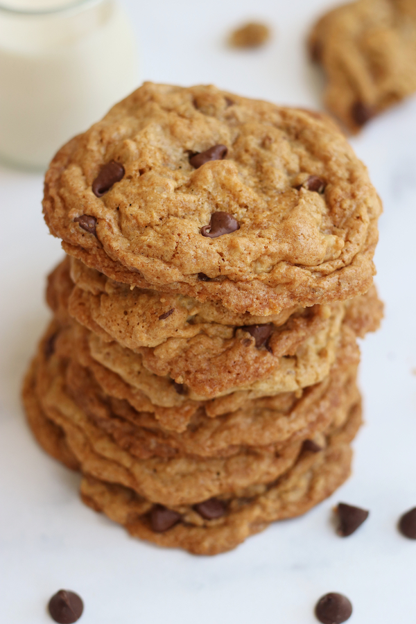 Seven Vegan Oatmeal Chocolate Chip Cookies stack on top of each other.