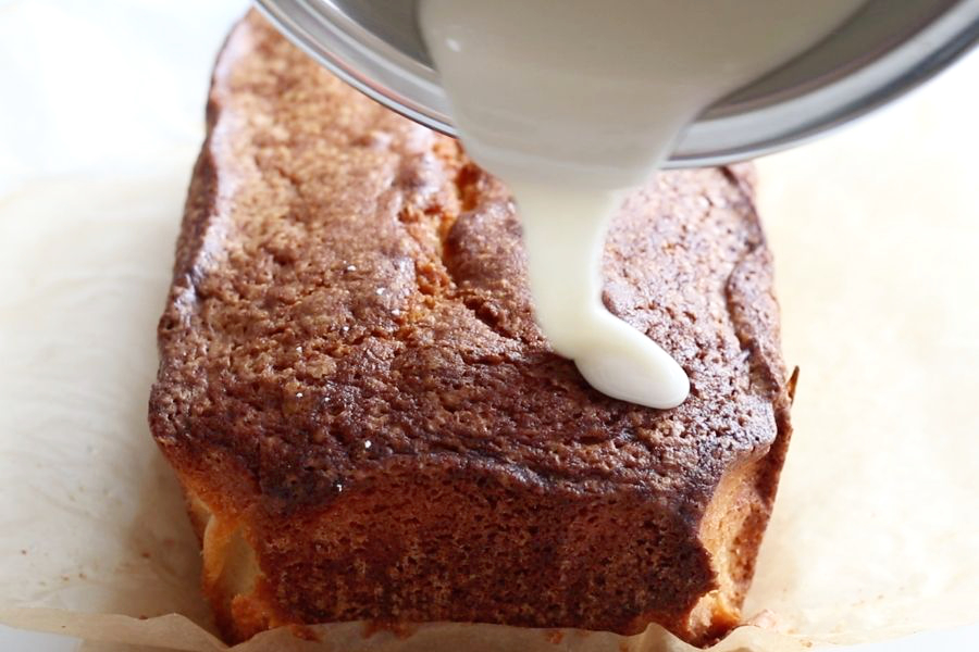 Pouring the first glaze on the top of Italian Lemon Pound Cake.