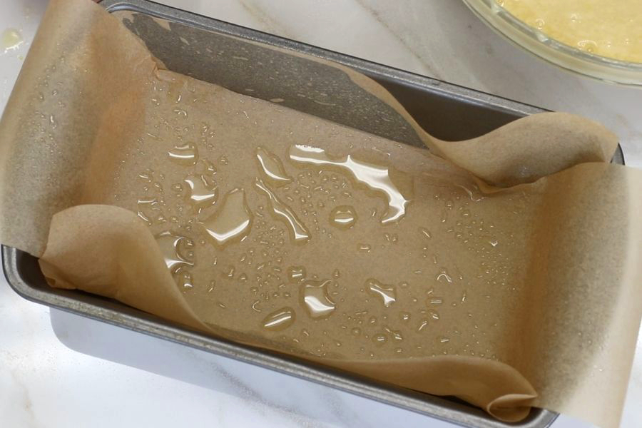 Parchment paper prepared loaf pan for Italian Lemon Loaf Cake.