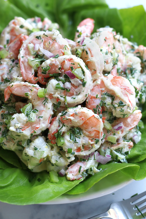 Shrimp Salad Recipe on a white plate sitting next to a fork.