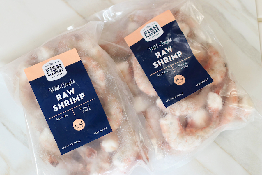 Two bags of Wild Caught Shrimp for Shrimp Salad laying on a countertop.