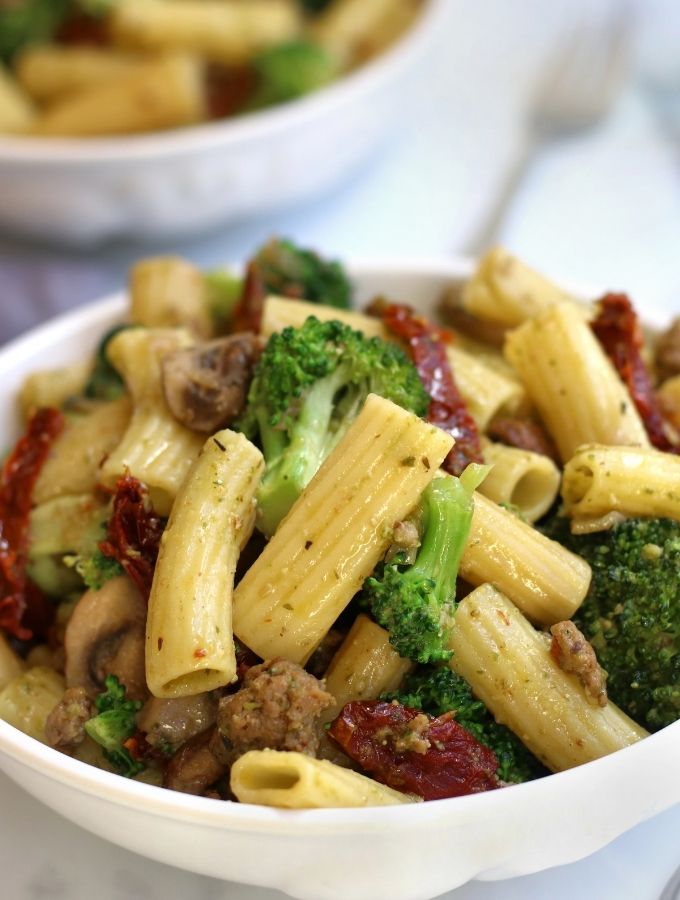 Sausage Pesto Pasta in a white Pasta bowl.