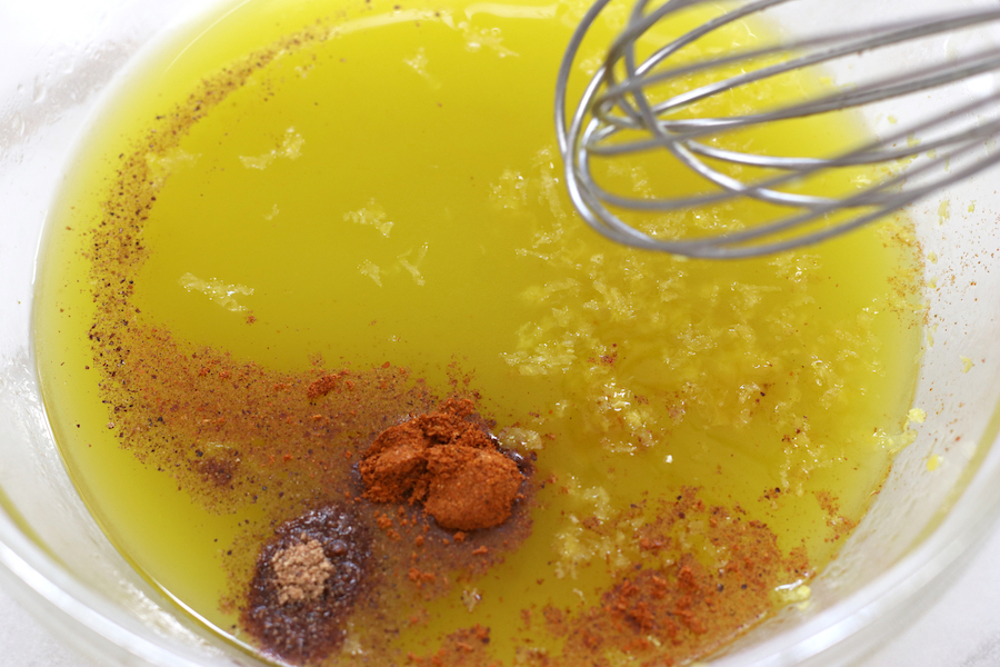 Adding spices, salt and lemon zest to vinaigrette for Tabbouleh.