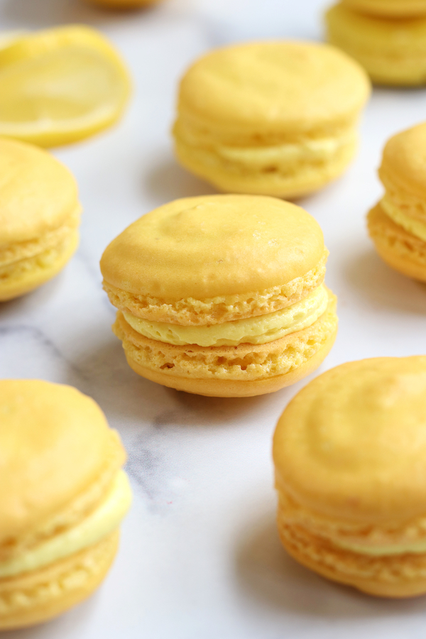 Several Lemon flavored Homemade Macarons lined up together.