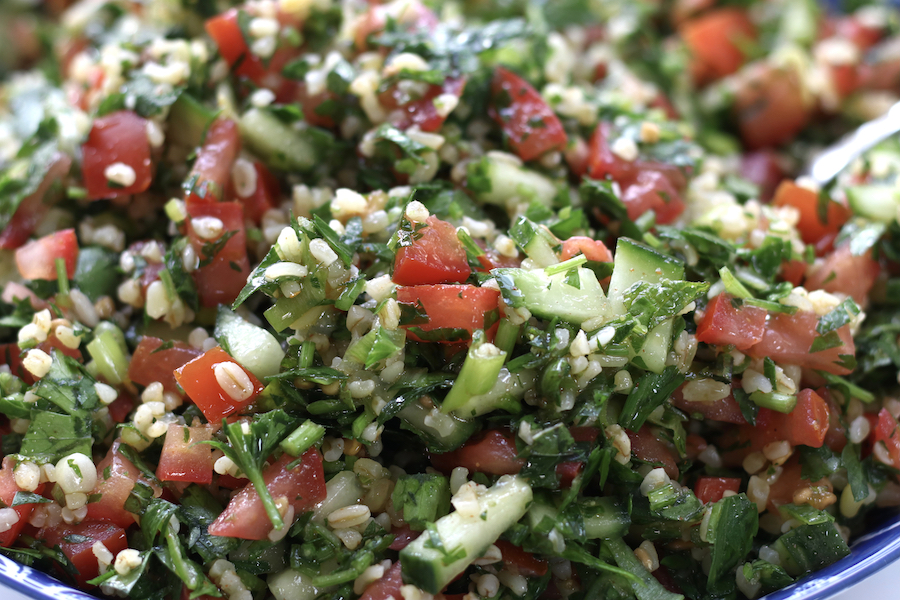 A very up close photo of Tabouleh with bulgar wheat.