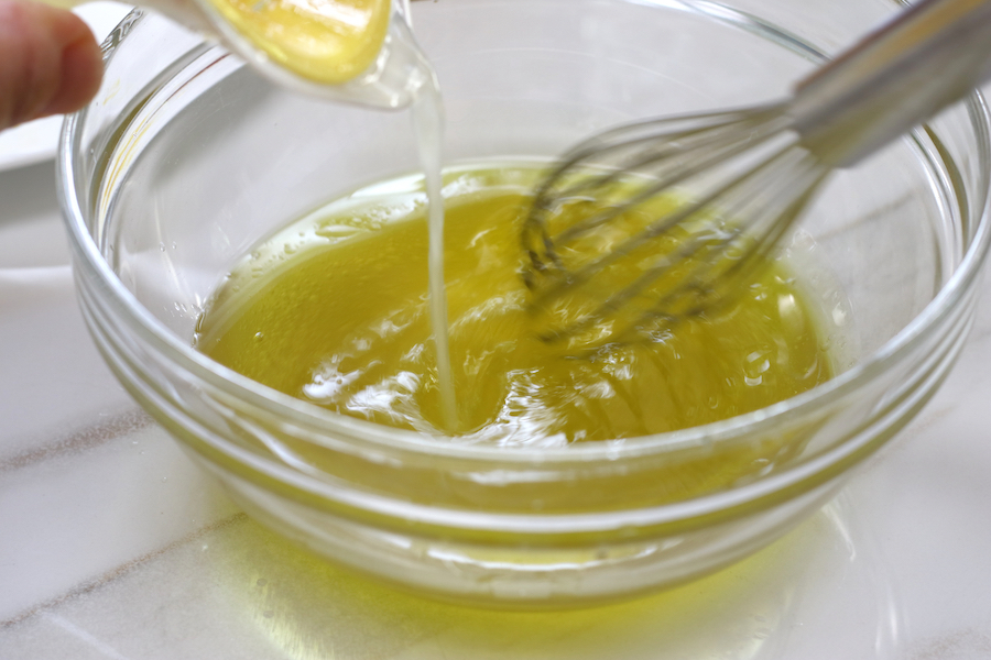 Whisking lemon juice into olive oil in making of vinaigrette for Tabouli Salad.