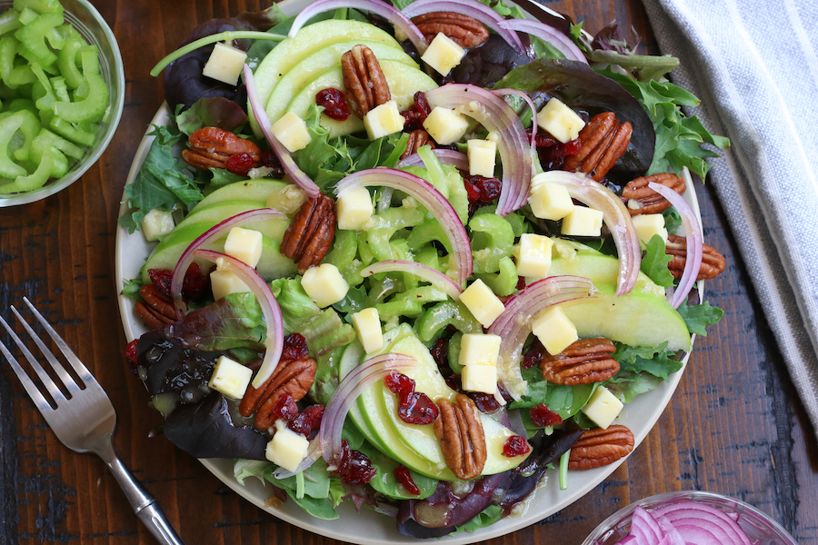 A serving of Fall Apple Salad with pecans, havarti cheese, red onions and celery.