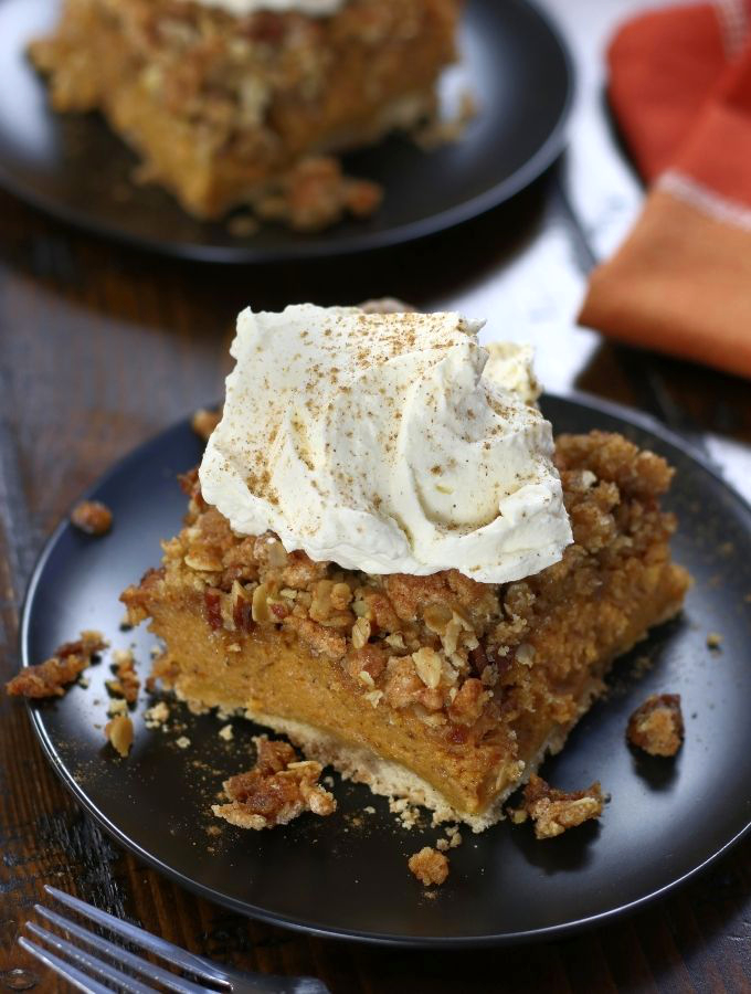A square of Pumpkin Crisp with a big dollop of homemade whipped cream.