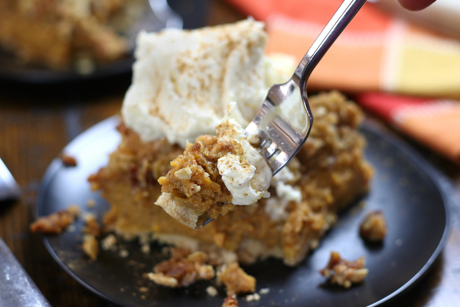 A forkful of Pumpkin Crumble with whipped cream.