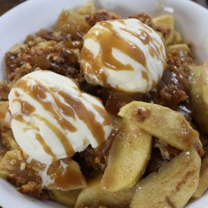 A serving of Apple Crisp with two scoops of ice cream.