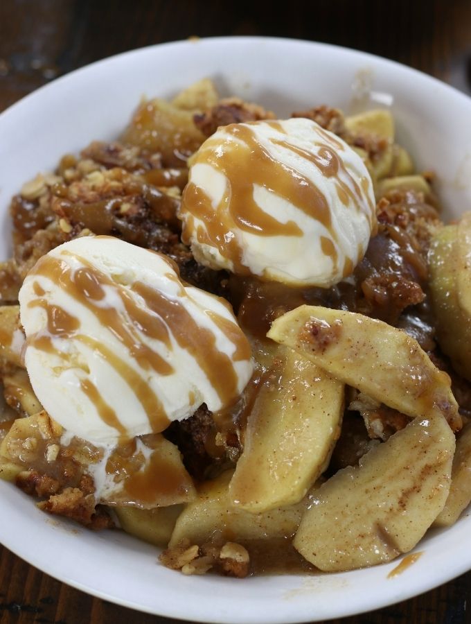 A serving of Apple Crisp with two scoops of ice cream.