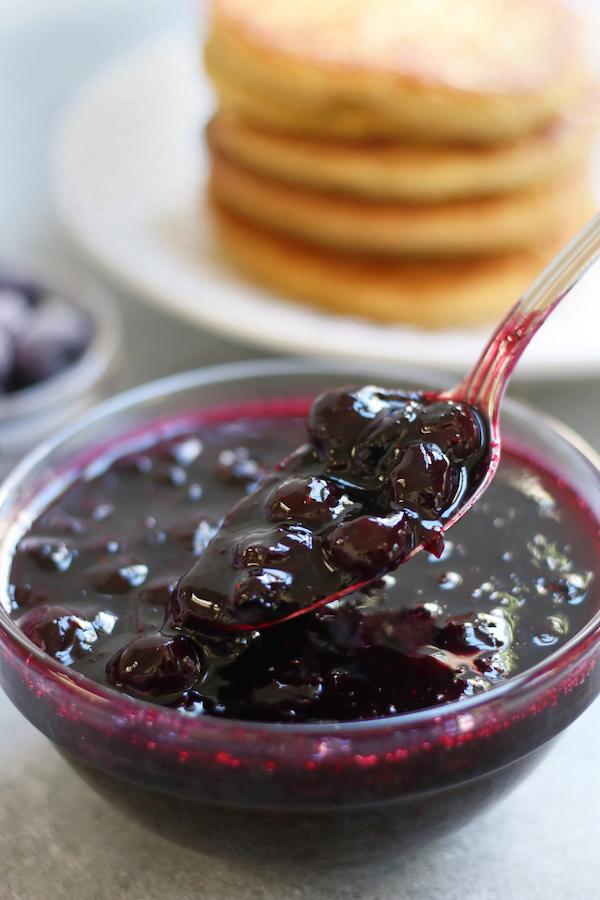 A small bowl and spoonful of Blueberries Compote.