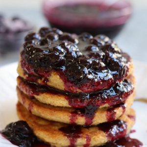 Blueberry Compote Recipe flowing down the side of pancakes.