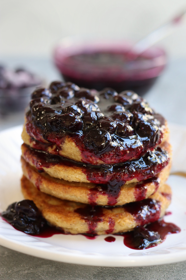 Blueberry Compote Recipe flowing down the side of pancakes.