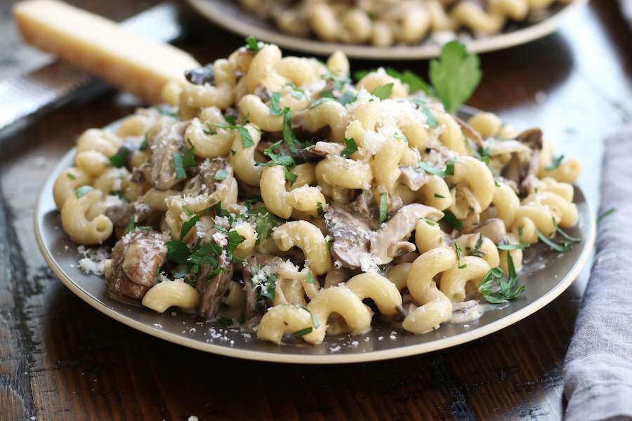 Cream of Mushroom Pasta garnished with parmesan and parsley.