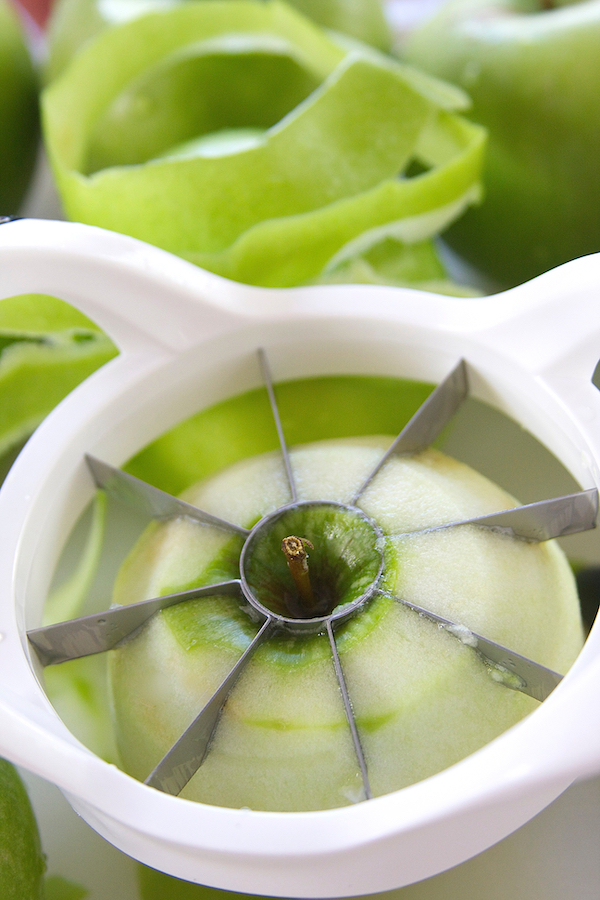 Photo showing how to cut apples for Apple Crisp using an apple slicer.