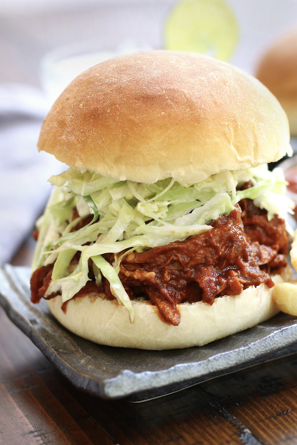 Pulled Chicken Burger sitting on a wavy grey plate.